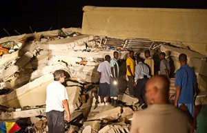 Rescuers and civilians search through the night for survivors